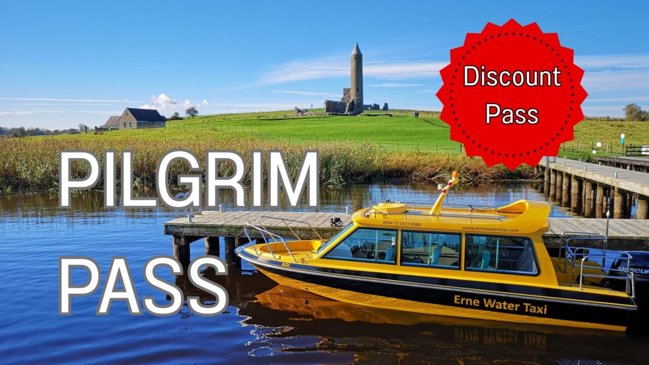 Yellow Water Taxi boat moored at the jetty with Devenish Tower shown in the background